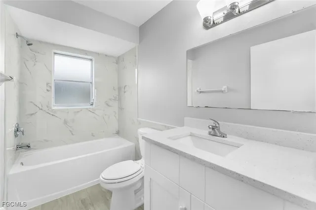 a bathroom with a sink toilet tub and vanity