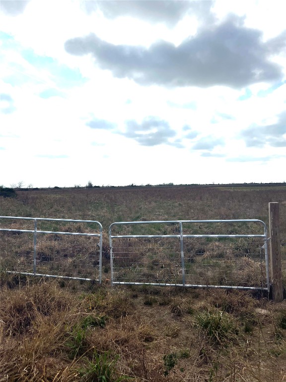a view of a yard with wooden fence