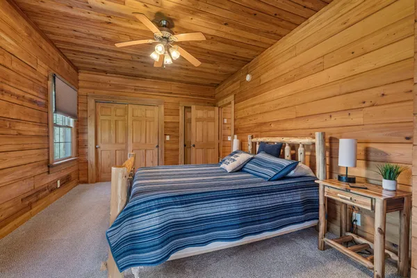 a bedroom with furniture and large window