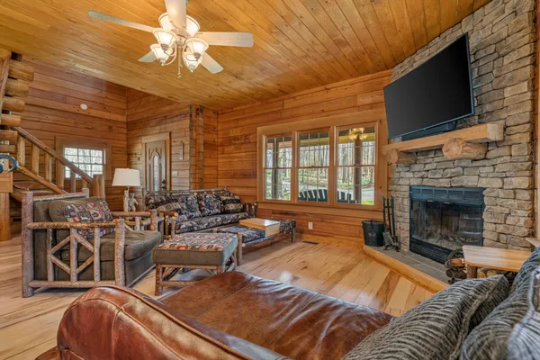 a living room with furniture fireplace and flat screen tv