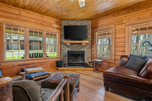 a living room with furniture a flat screen tv and a fireplace