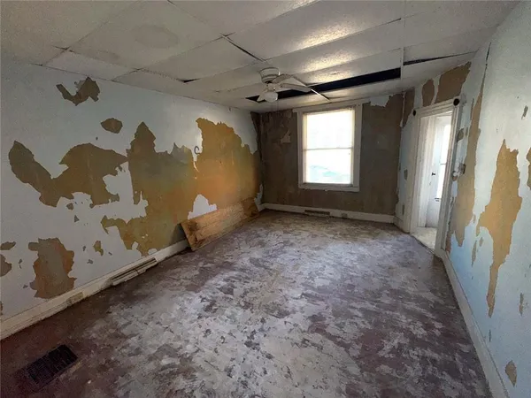 a view of empty room with a fireplace