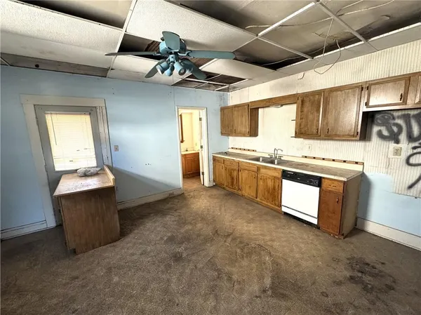 a kitchen with stainless steel appliances granite countertop a sink and a refrigerator