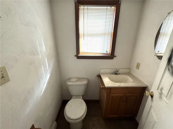 a bathroom with a toilet sink and mirror
