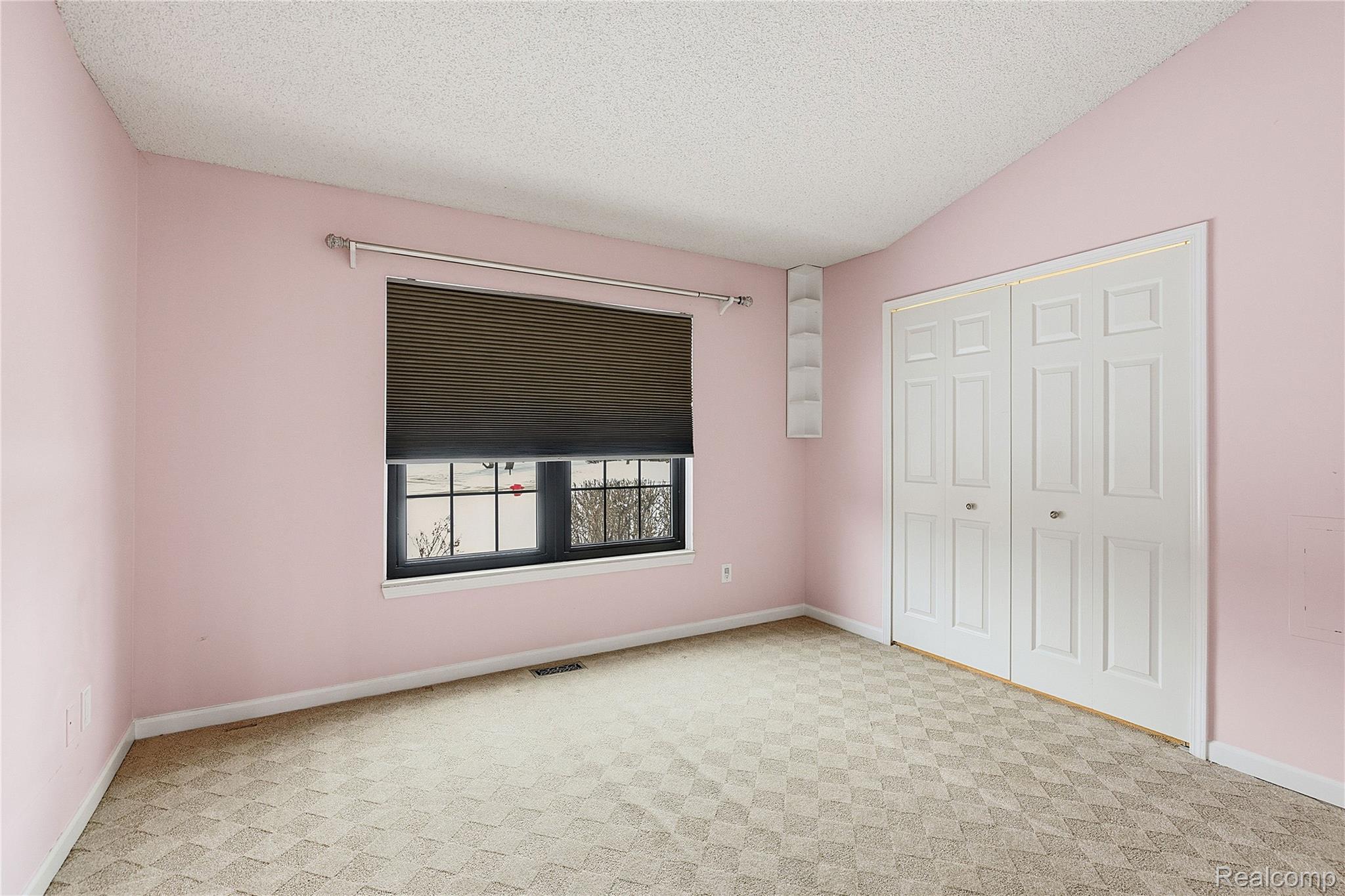 7154 Westchester Road West Bloomfield, MI 48322 - Photo 20 of 38 Unfurnished bedroom featuring a textured ceiling, light colored carpet, a closet, and vaulted ceiling