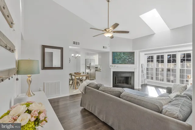 a living room with furniture fireplace and a window