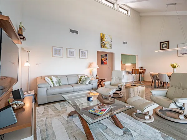 a living room with furniture a rug and a window