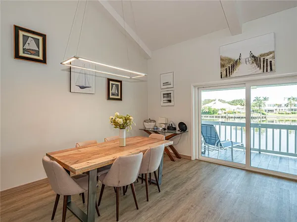 a dining room with furniture and wooden floor