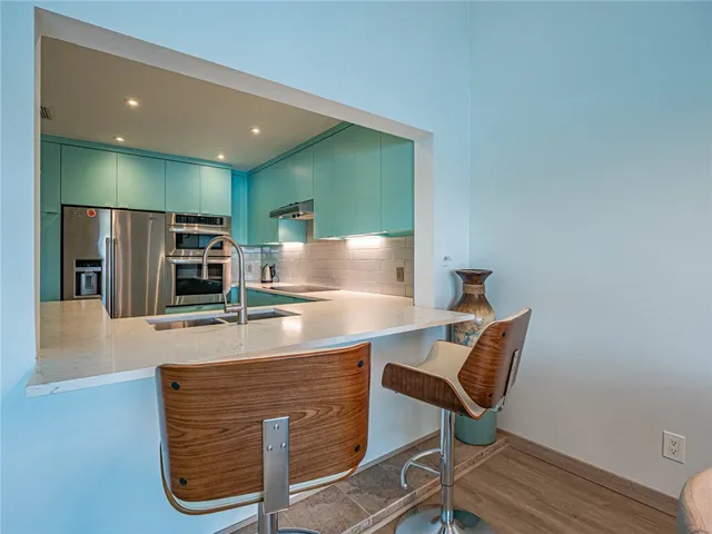 a room with table chairs and wooden floor