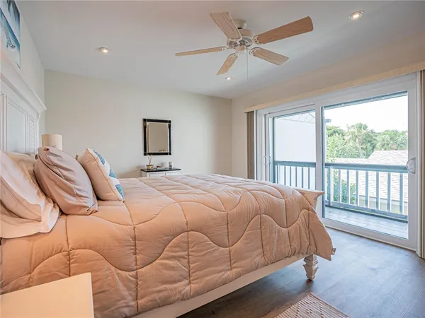 a bedroom with a large bed and a large window