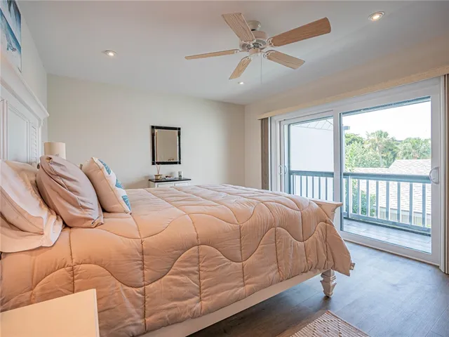 a bedroom with a large bed and a large window