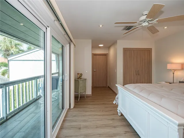 a spacious bedroom with a bed and a chandelier