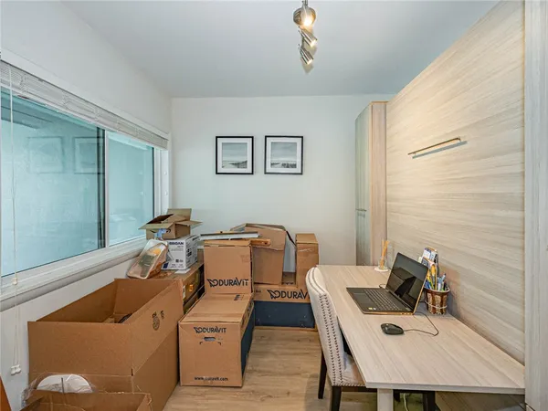 a room with a table chairs and wooden floor