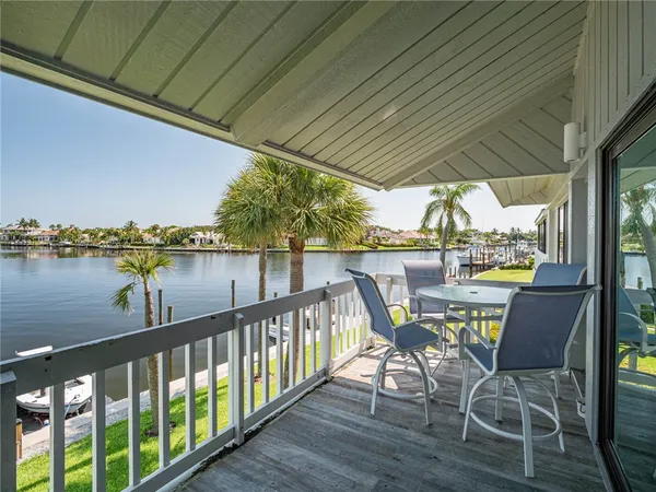 a view of a chairs and table in the balcony