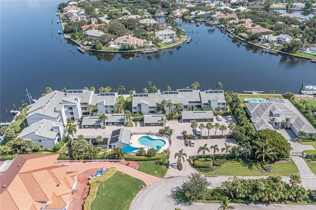 an aerial view of a house with a yard swimming pool and outdoor seating