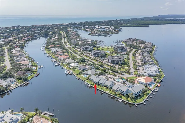 an aerial view of a houses with a lake