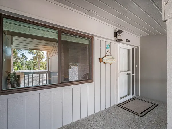 a view of a porch with a table and chairs