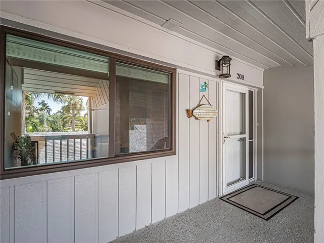 a view of a porch with a table and chairs