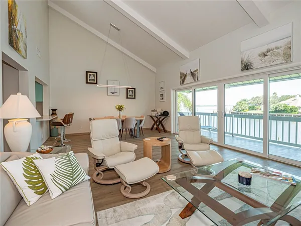 a living room with furniture and a floor to ceiling window