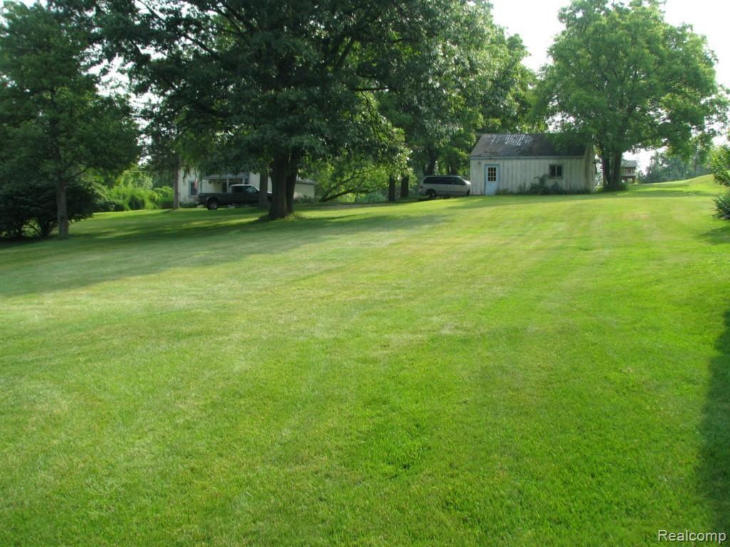 9334 Hilton Road Brighton, MI 48114 - Photo 13 of 34 Yard view across lawn toward neighboring property to the east