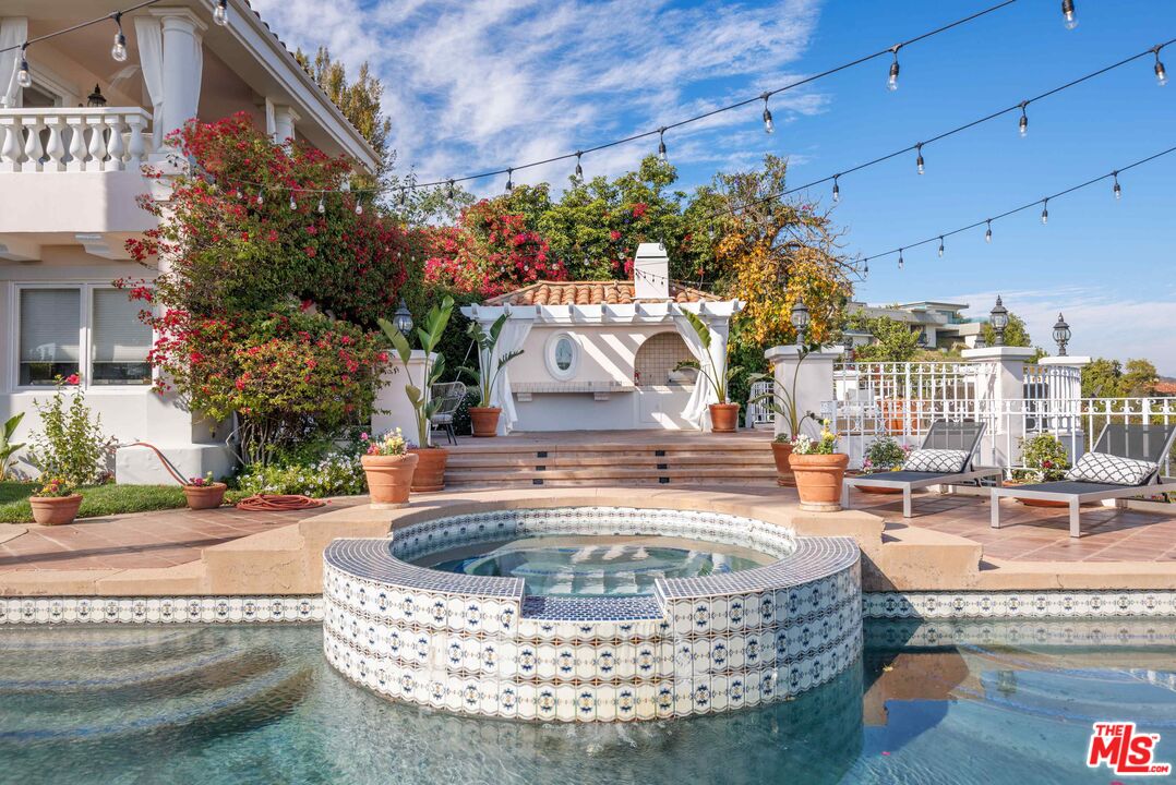 1100 Stradella Road Los Angeles, CA 90077 - Photo 11 of 26 a view of a swimming pool with a patio