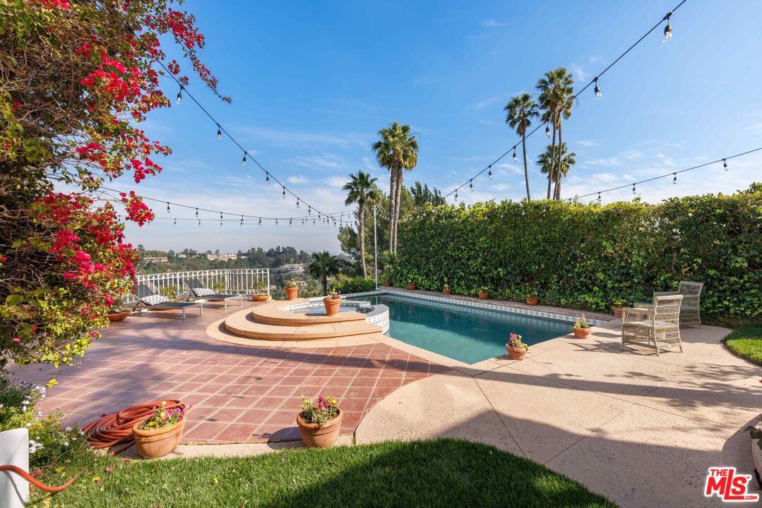1100 Stradella Road Los Angeles, CA 90077 - Photo 13 of 26 a view of a swimming pool with a patio