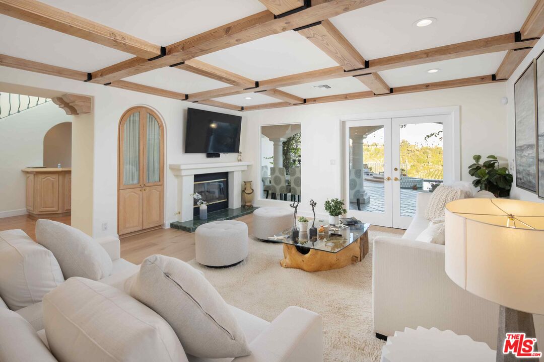 1100 Stradella Road Los Angeles, CA 90077 - Photo 18 of 26 a living room with furniture fireplace and a flat screen tv
