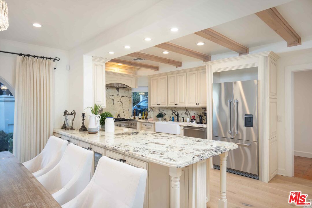 1100 Stradella Road Los Angeles, CA 90077 - Photo 19 of 26 a kitchen with granite countertop a table and chairs