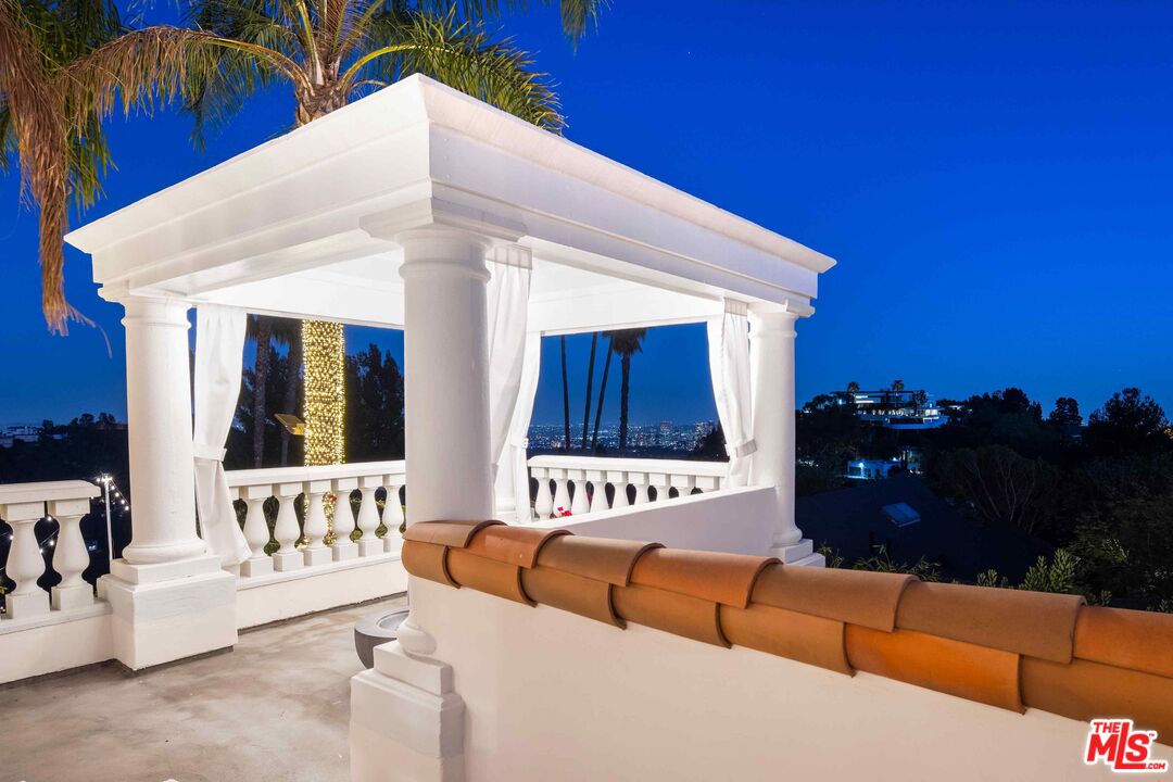 1100 Stradella Road Los Angeles, CA 90077 - Photo 25 of 26 a view of a couches and a tables and chairs in patio