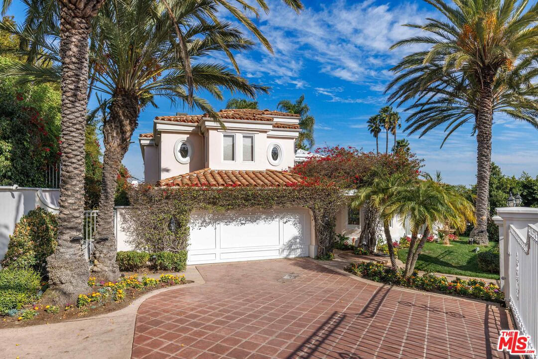 1100 Stradella Road Los Angeles, CA 90077 - Photo 3 of 26 a front view of a house with a yard