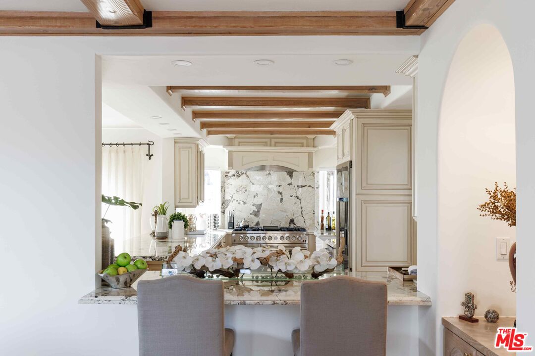 1100 Stradella Road Los Angeles, CA 90077 - Photo 4 of 26 a living room with furniture and a potted plant