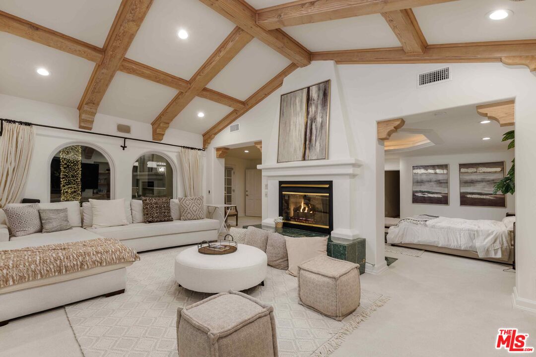 1100 Stradella Road Los Angeles, CA 90077 - Photo 8 of 26 a living room with furniture and a fireplace