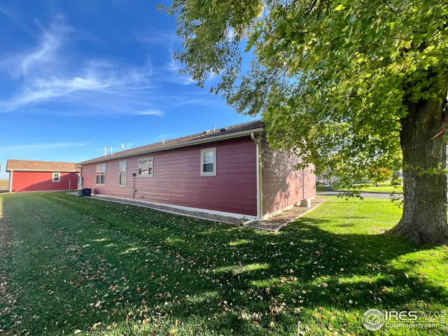 a view of a backyard with large trees
