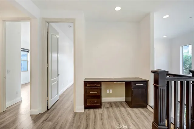 a view of hallway with wooden floor
