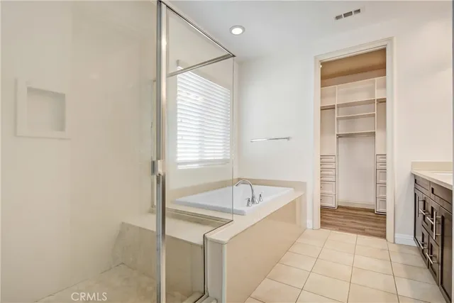 a bathroom with a tub sink and a window