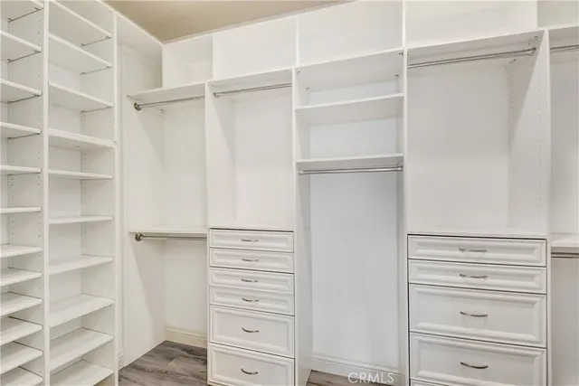 a view of walk in closet with empty racks