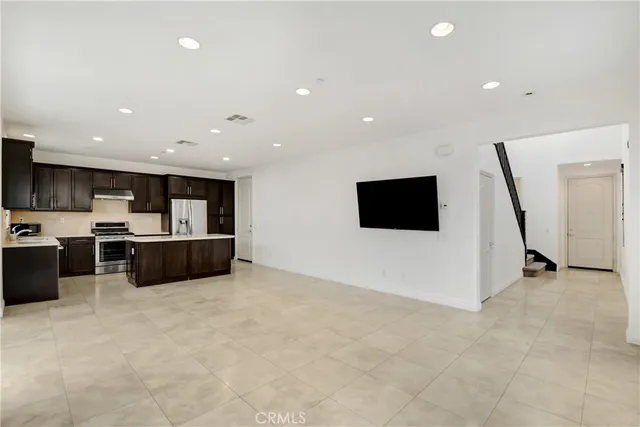 a view of kitchen with stainless steel appliances kitchen island microwave and stove