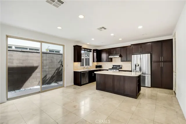 a kitchen with stainless steel appliances a refrigerator and a cabinets