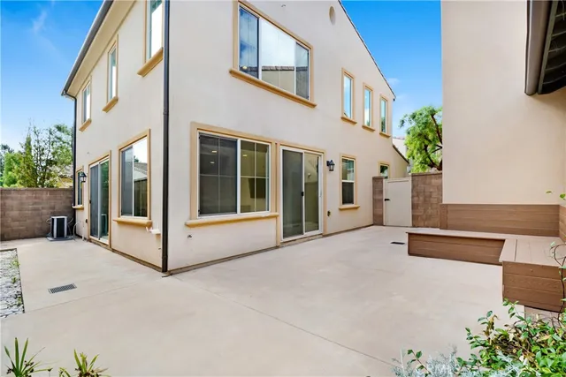 a view of an entryway with a floor to ceiling window and potted plants