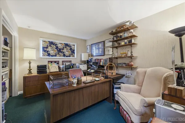 a living room with furniture a rug and a wall painting