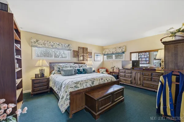 a bedroom with a bed and dresser