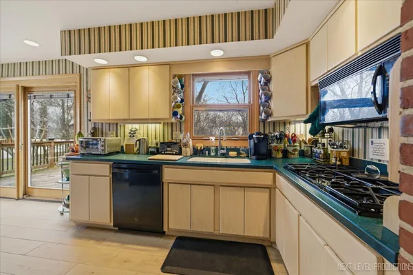 a kitchen with stainless steel appliances granite countertop a stove and a sink