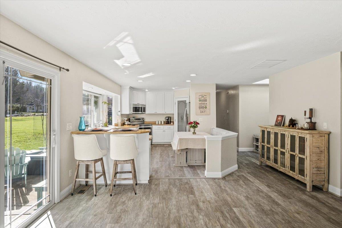 11195 Ringtail Road Penn Valley, CA 95946 - Photo 12 of 47 a view of a dining room with furniture window and wooden floor