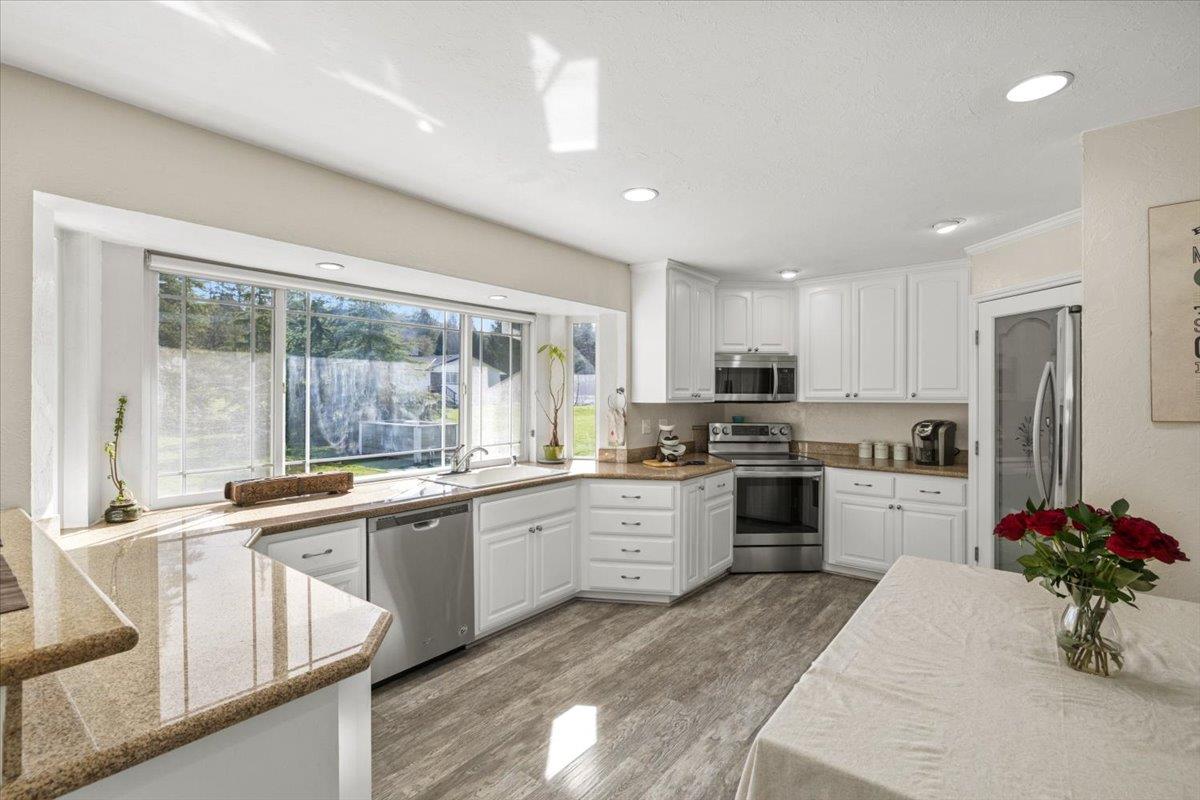 11195 Ringtail Road Penn Valley, CA 95946 - Photo 14 of 47 a kitchen with a sink stove top oven and refrigerator
