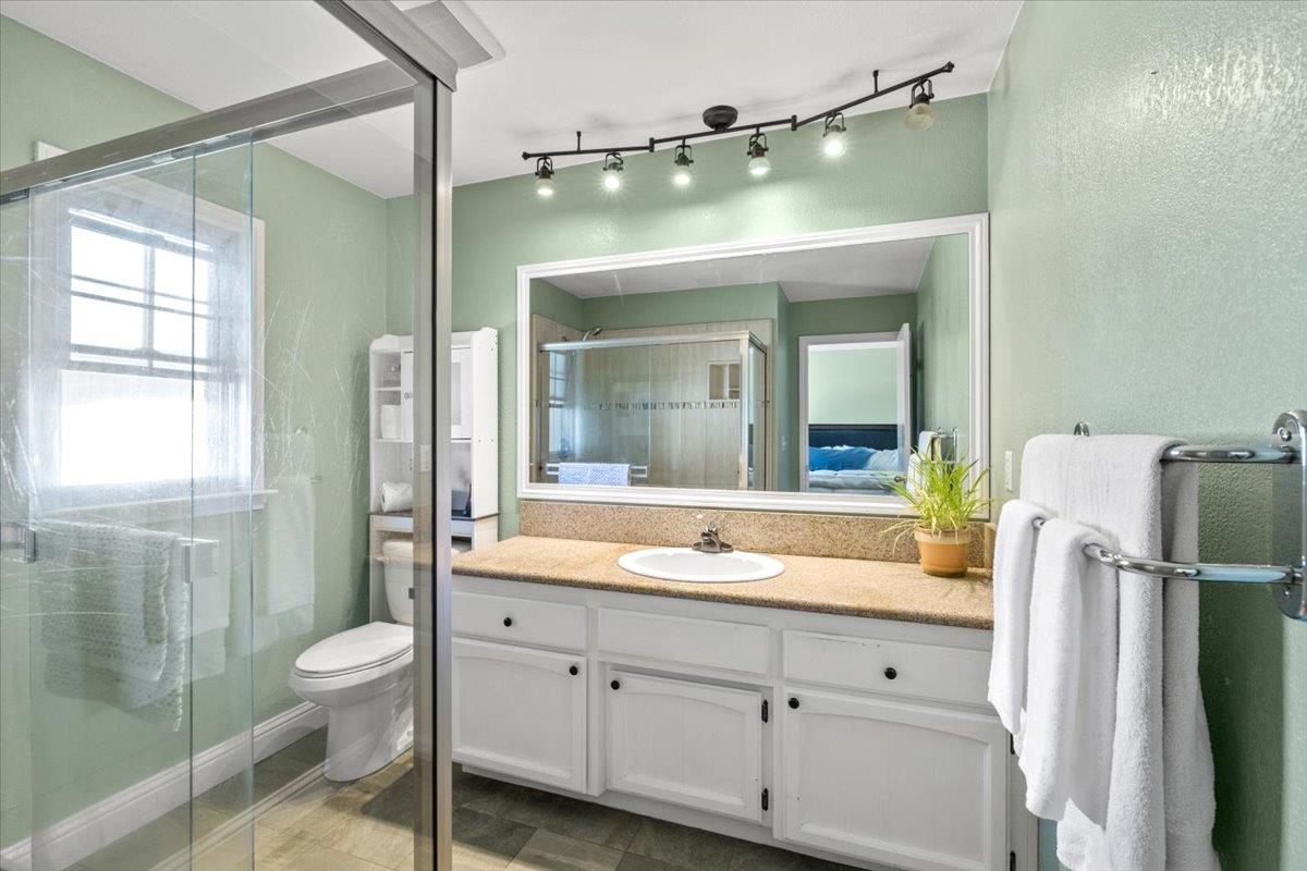 11195 Ringtail Road Penn Valley, CA 95946 - Photo 20 of 47 a spacious bathroom with a double vanity sink toilet mirror and shower