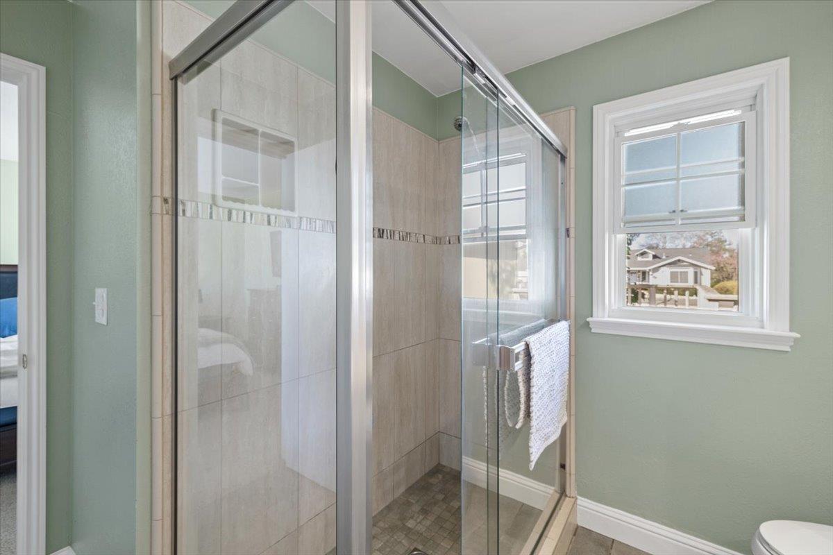11195 Ringtail Road Penn Valley, CA 95946 - Photo 21 of 47 a bathroom with a glass shower door and a window