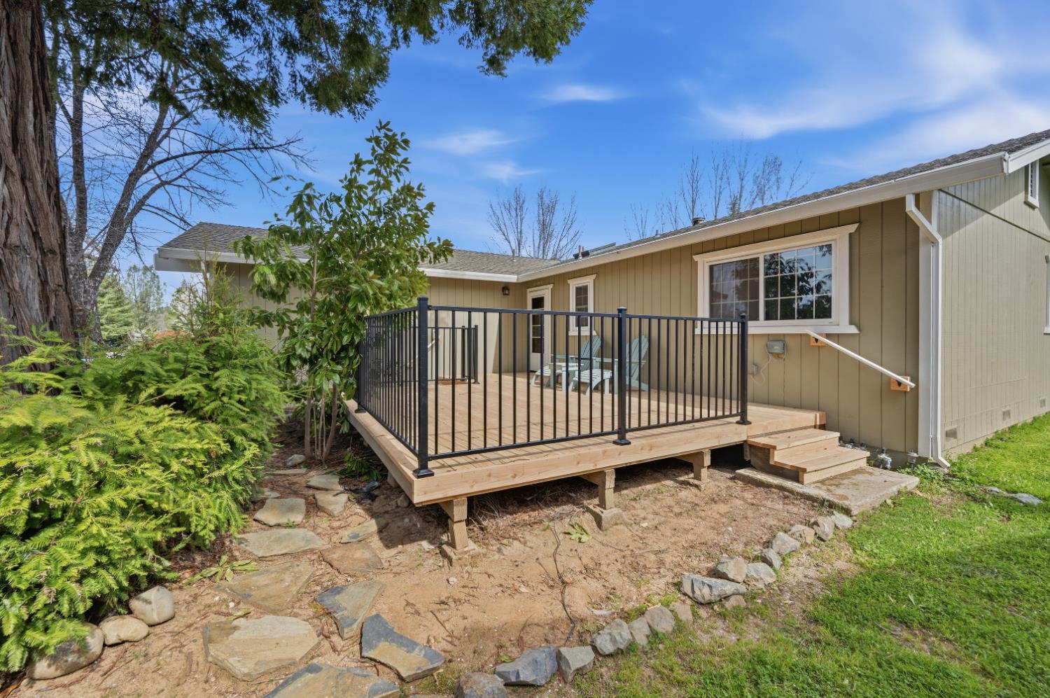 11195 Ringtail Road Penn Valley, CA 95946 - Photo 3 of 47 a view of a small yard with wooden fence and large trees