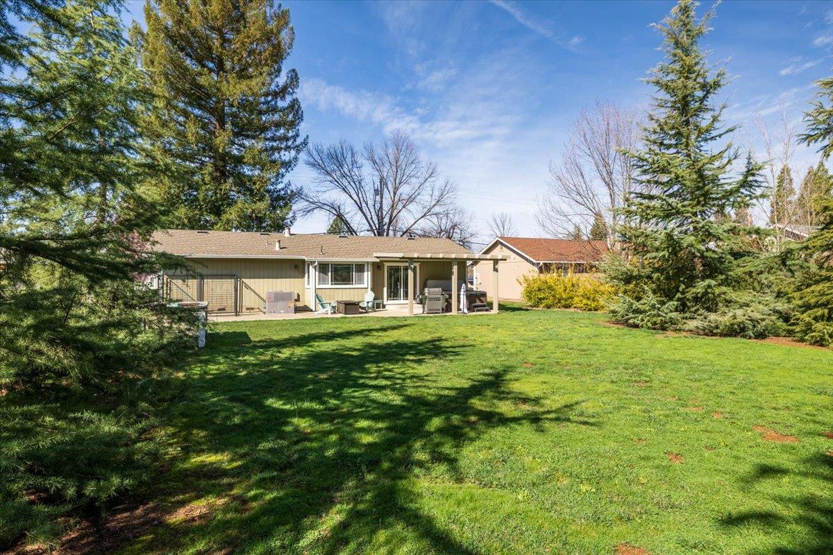 11195 Ringtail Road Penn Valley, CA 95946 - Photo 31 of 47 a front view of a house with a yard table and chairs