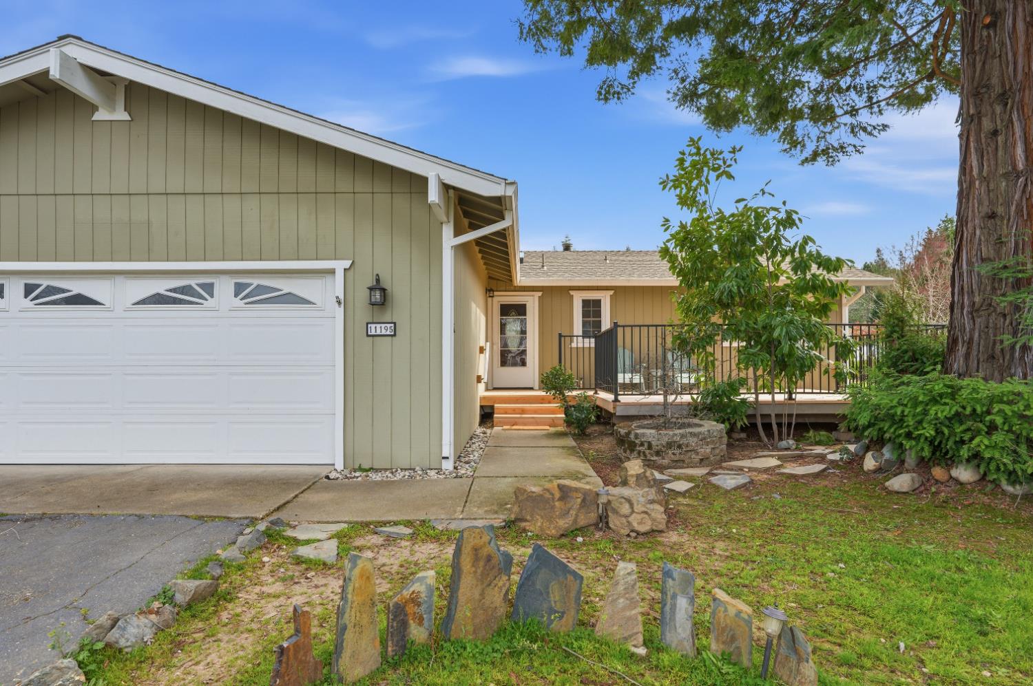 11195 Ringtail Road Penn Valley, CA 95946 - Photo 47 of 47 a backyard of a house with table and chairs plants and large tree