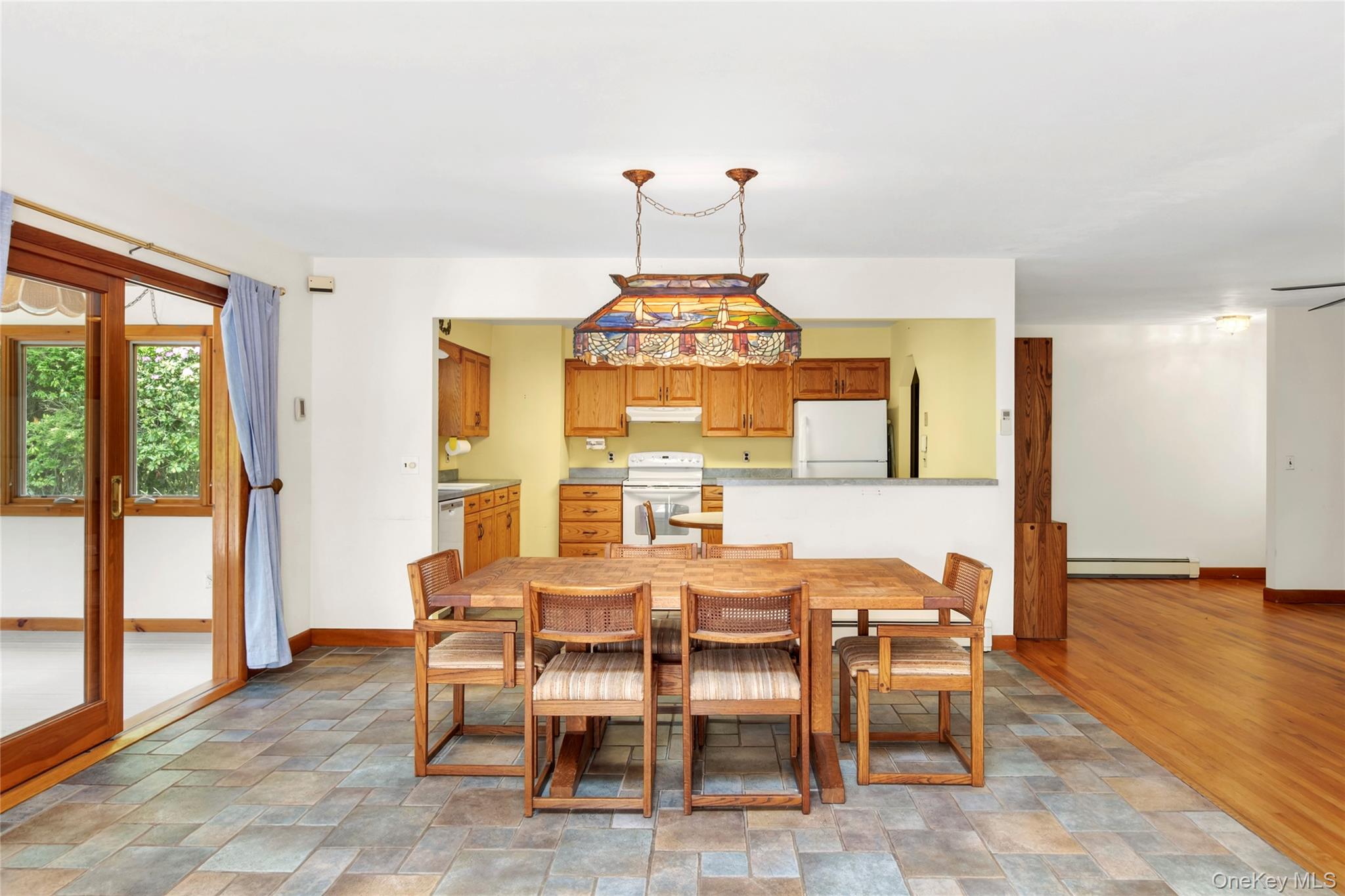 250 Paradise Point Road Southold, NY 11971 - Photo 5 of 24 a view of a dining room with furniture wooden floor and chandelier